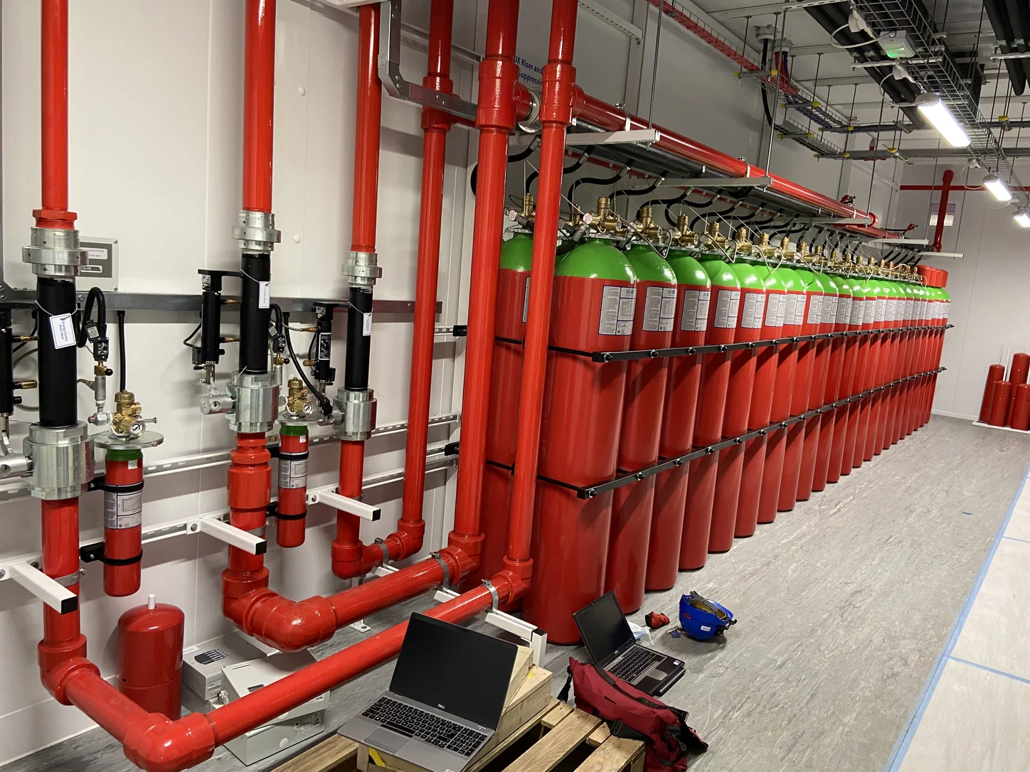 Fire suppression system cylinders and pipework in a plant room